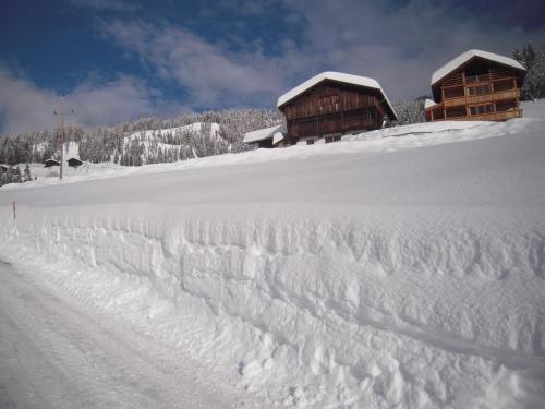 a pile of snow in front of a cabin at Haus am Sonnenberg in Liesing