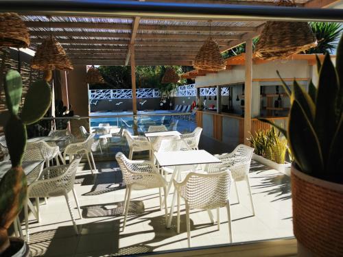 a patio with white chairs and tables and a pool at Europa Hotel in Rhodes Town