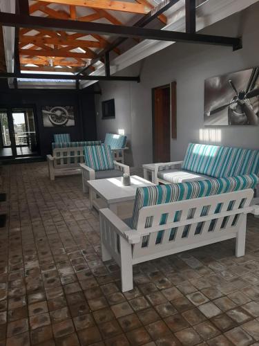 a room with couches and a table and chairs at The Hank Bethlehem Pty Ltd in Bethlehem