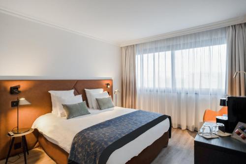 Letto o letti in una camera di Appart'City Collection Genève Aéroport - Ferney Voltaire