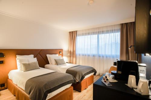 Letto o letti in una camera di Appart'City Collection Genève Aéroport - Ferney Voltaire