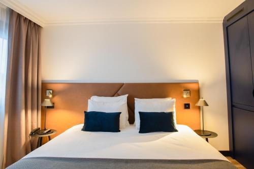 Letto o letti in una camera di Appart'City Collection Genève Aéroport - Ferney Voltaire