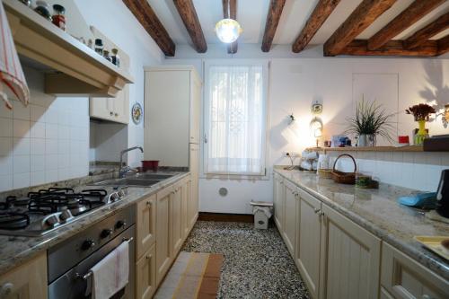 a kitchen with a sink and a stove top oven at Briati apartment in Venice