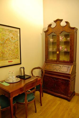 a room with a table and a china cabinet at Navona Residenza de Charme in Rome