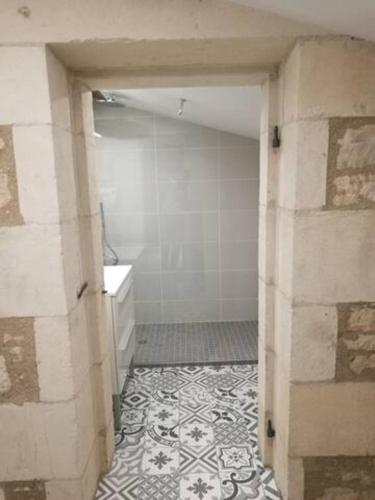 an open door to a bathroom with a shower at Château des Loups - Les Cèdres Bleus in Échiré