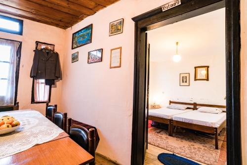 a room with a bed and a table and a mirror at Etno House Shancheva in Kratovo