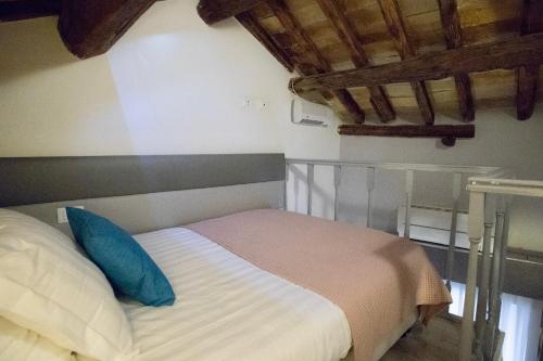 a bedroom with a bed with a blue pillow at Navona Residenza de Charme in Rome