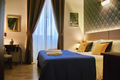 a hotel room with a bed and a large window at Navona Residenza de Charme in Rome