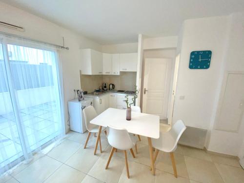 馬賽的住宿－Appartement la plage de la pointe rouge，厨房以及带桌椅的用餐室。