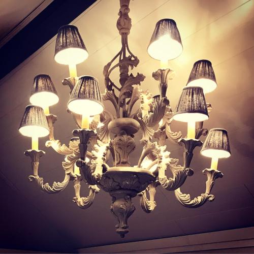 a large chandelier hanging from a ceiling at Le petit béguinage in Tongeren