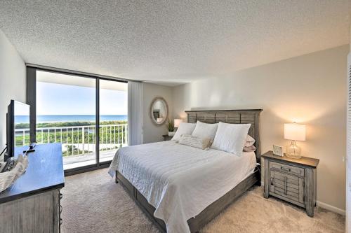 a bedroom with a bed and a large window at Resort Condo with Balcony and Stunning Ocean Views! in Marco Island