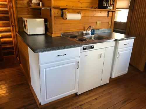 a kitchen with a sink and a counter top at Beyul Retreat in Meredith