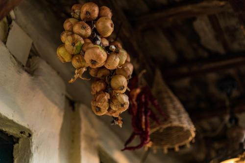 a bunch of onions hanging from a ceiling at Etno House Shancheva in Kratovo