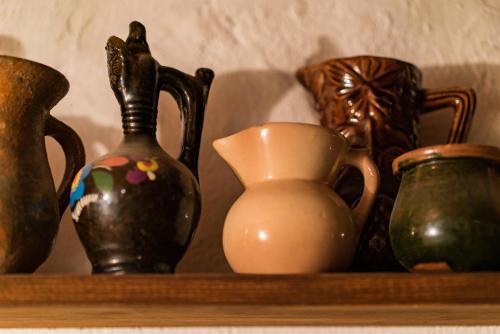 a shelf with many different vases on it at Etno House Shancheva in Kratovo