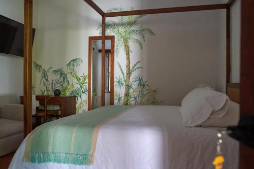 a bedroom with a white bed with a canopy at San Rafael in Mompos