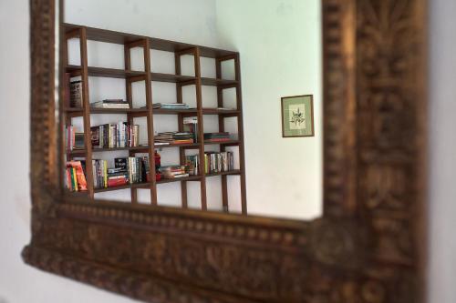 a mirror reflection of a book shelf with books at San Rafael in Mompos