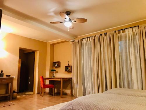 a bedroom with a bed and a ceiling fan at VNVP Amber in Štip