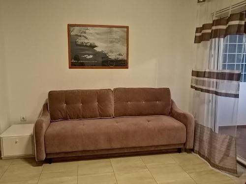 a brown couch sitting in a living room at Apartments Purkovic in Vodice