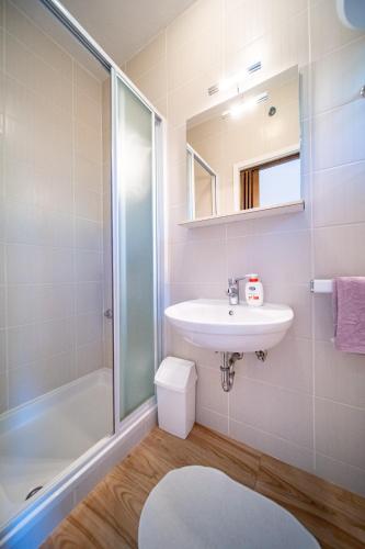 a bathroom with a sink and a shower at Apartmani Milena in Rab