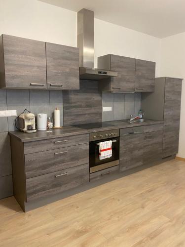 a kitchen with stainless steel cabinets and an oven at Ferienwohnung neben dem Schloss Porcia in Spittal an der Drau