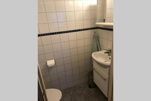 a bathroom with a toilet and a sink at Villa med fantastisk utsikt in Båstad