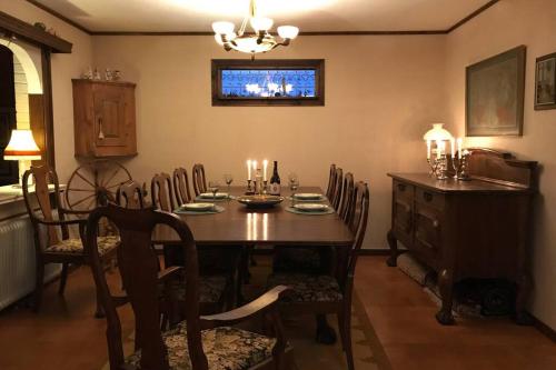 a dining room with a table and chairs and a television at Villa med fantastisk utsikt in Båstad