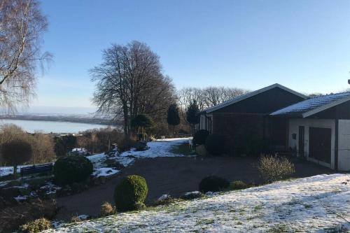 a house in the snow with a view of the water at Villa med fantastisk utsikt in Båstad