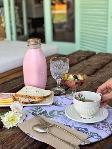 a table with a pink jar and a plate of food at Casa Lola in Yerba Buena