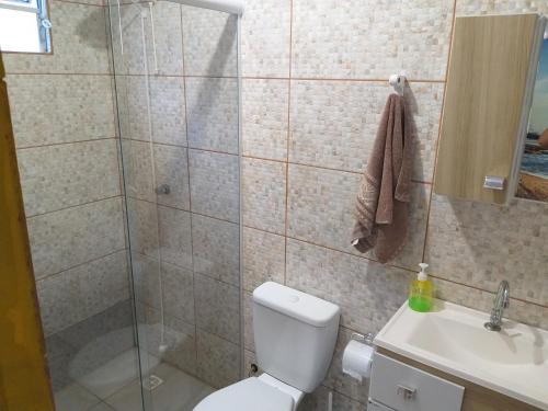 a bathroom with a shower and a toilet and a sink at Morada Sol e Lua Container Guarda do Embaú com Ar condicionado in Guarda do Embaú