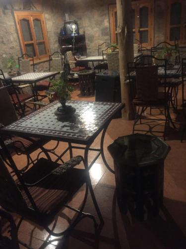 a table with a potted plant on top of it at Auberge Le Festival Todra Gorge in Aït Baha