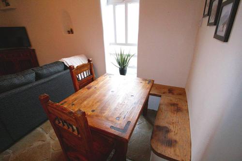 a wooden table and chairs in a living room at Closson Casita - Patio & Fire Pit - Near Plaza - 1BR in Santa Fe