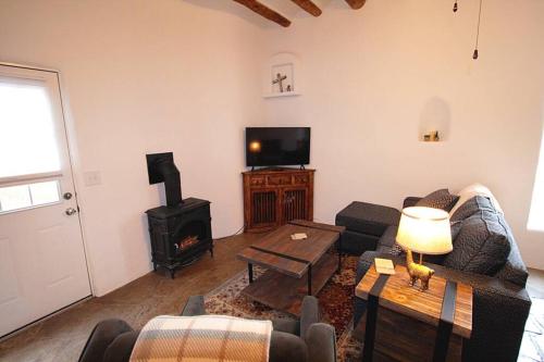 a living room with a couch and a stove at Closson Casita - Patio & Fire Pit - Near Plaza - 1BR in Santa Fe