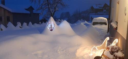 a snowman made out of snow in a yard at B&B SognoInCadore in Domegge di Cadore