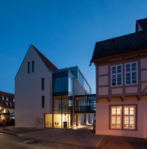 a large white building with a glass facade at Hotel Stadtpalais in Lemgo
