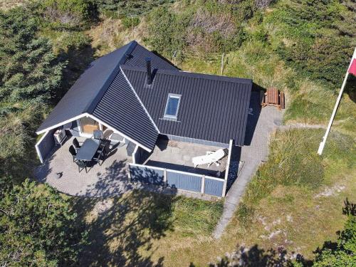 an overhead view of a house with a dog at 6 person holiday home in Ringk bing in Klegod
