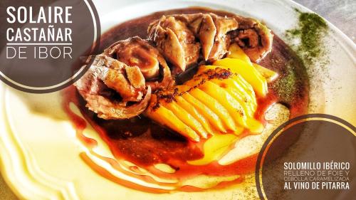 a magazine cover of a plate of food with meat and sauce at Hostal Restaurante Solaire in Castañar de Ibor
