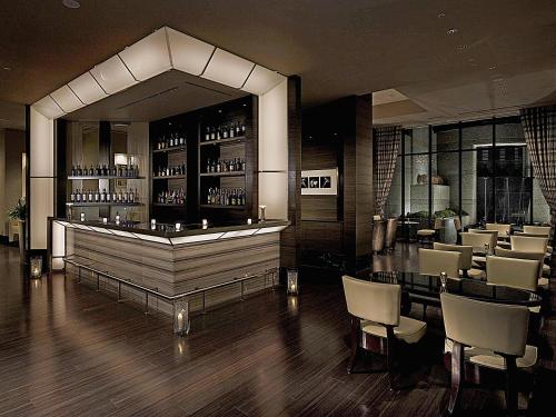 a restaurant with a bar with a lot of chairs at Hotel Trusty Tokyo Bayside in Tokyo