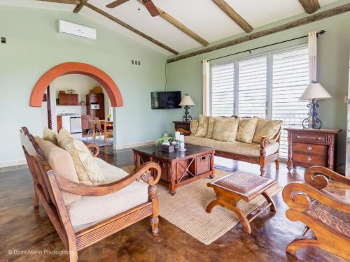 a living room with a couch and a table at Almond Tree Hotel Resort in Corozal