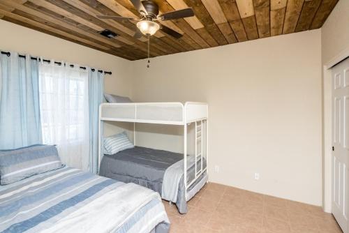 - une chambre avec 2 lits et un ventilateur de plafond dans l'établissement NEW! Desert Pool & Spa Home, Minutes To Beach!, à Lake Havasu City