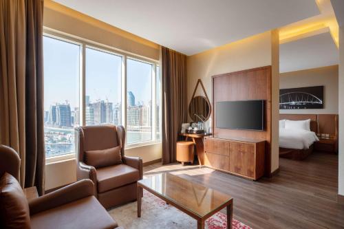 A bed or beds in a room at Radisson Blu Hotel, Dubai Canal View
