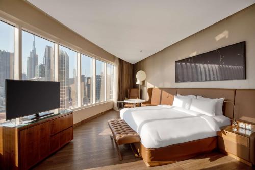 A bed or beds in a room at Radisson Blu Hotel, Dubai Canal View