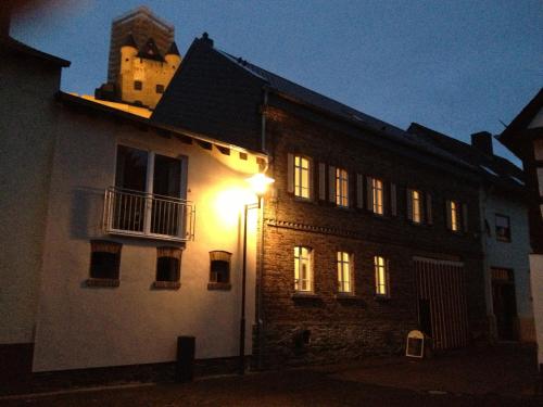 a light shines on the side of a building at night at Gästehaus "Auszeit" in Burgschwalbach