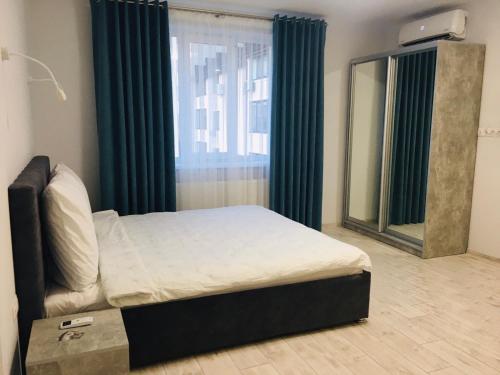 a bedroom with a bed in front of a window at APARTMENT EDELWEISS in Uzhhorod