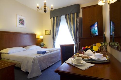 Postel nebo postele na pokoji v ubytování Hotel Posta