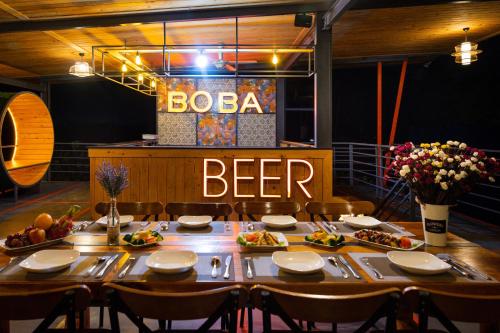 a dining room with a table and a beer sign at Cồn Phụng Resort Mekong - Nature Escape with Free Boat Shuttle & Fishing in Ben Tre