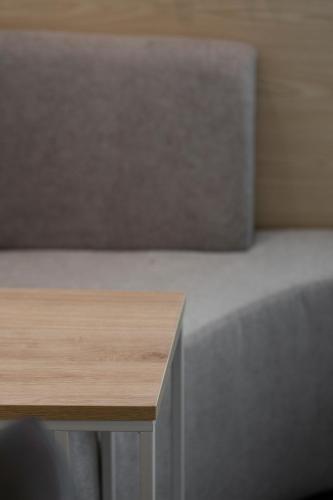 a wooden table in a room with a table at Busan Lounge 26 Hotel in Busan