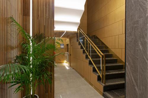 a staircase in a building with a potted plant at Busan Lounge 26 Hotel in Busan