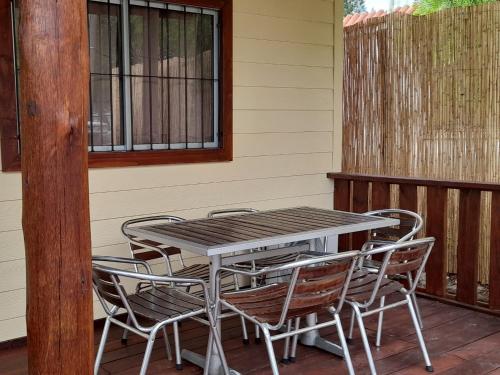 a table and chairs on the porch of a house at El Miyagi in Piriápolis