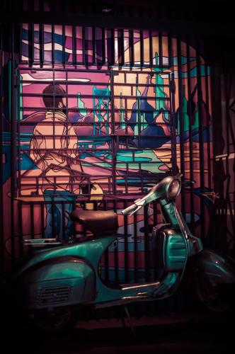 a scooter parked in front of a room with a painting at Zoot Kochi Infopark in Cochin