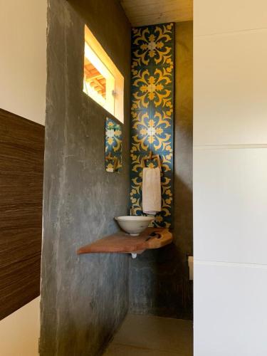 a bathroom with a sink on a wall at Casa Amarela - 3 suítes e piscina in Piranhas